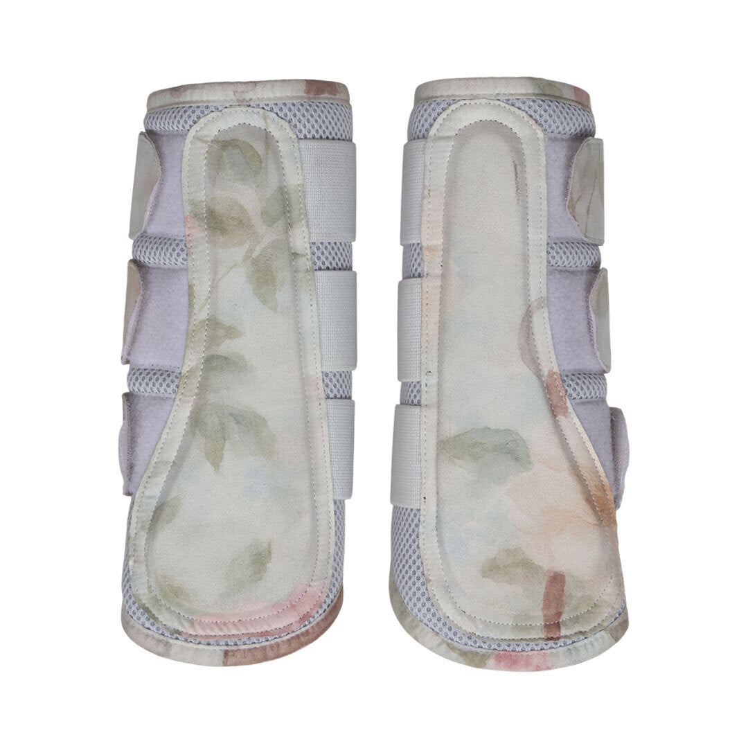 Pair of equestrian leg wraps with floral pattern on a white background
