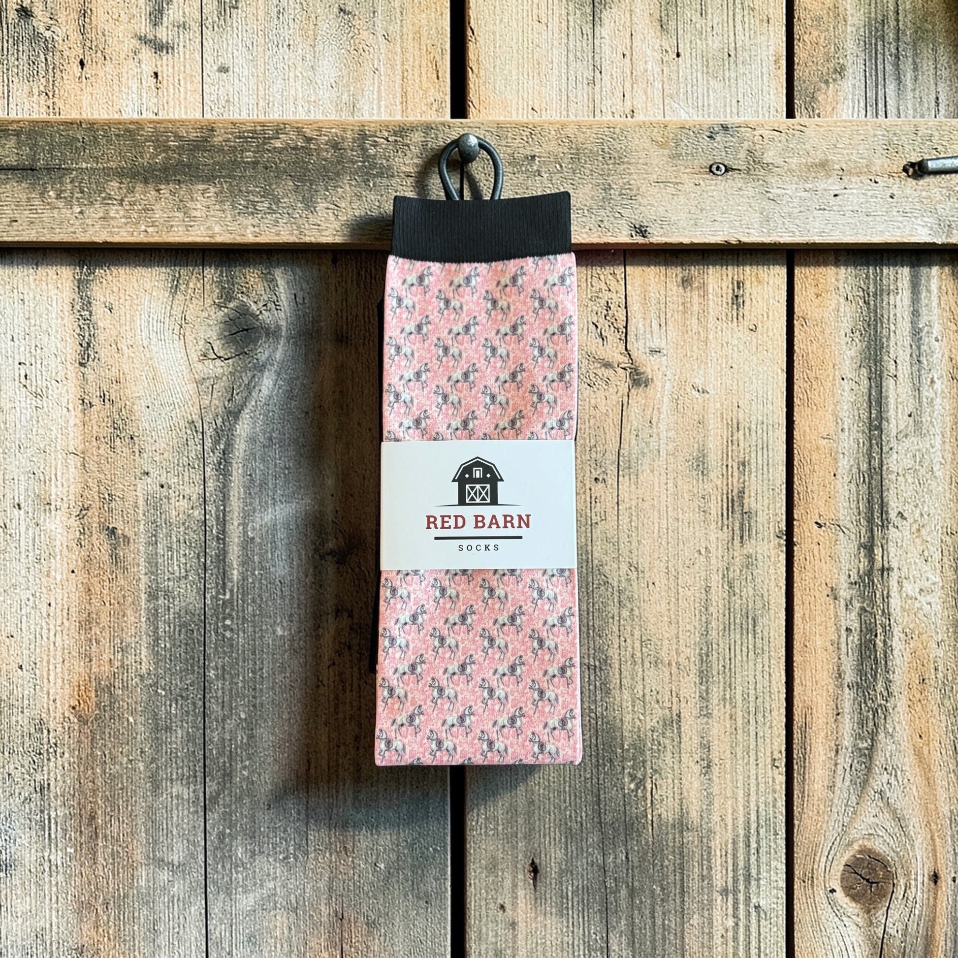 Pack of socks with a 'Red Barn' label on a wooden background