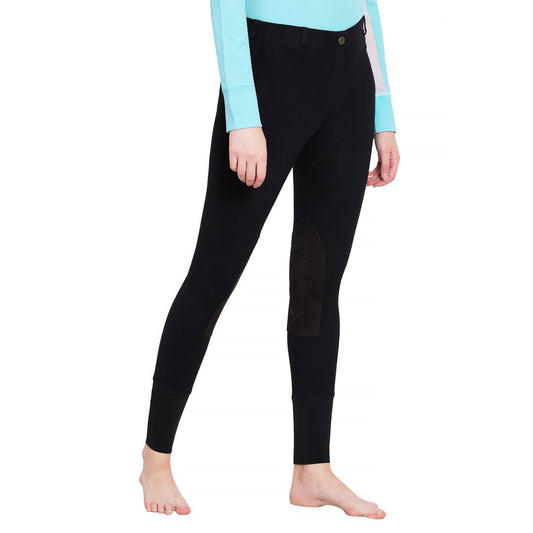 Black riding pants worn by a person on a white background
