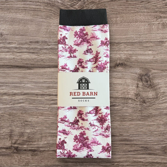 Red Barn Socks packaging with floral pattern on a wooden surface