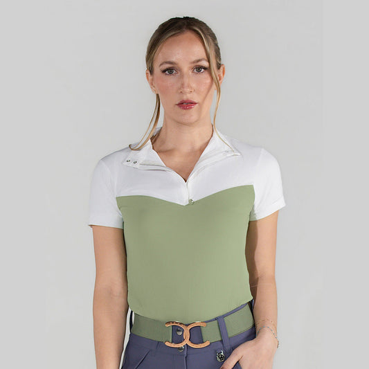 Woman wearing a two-tone shirt with a belt on a plain background
