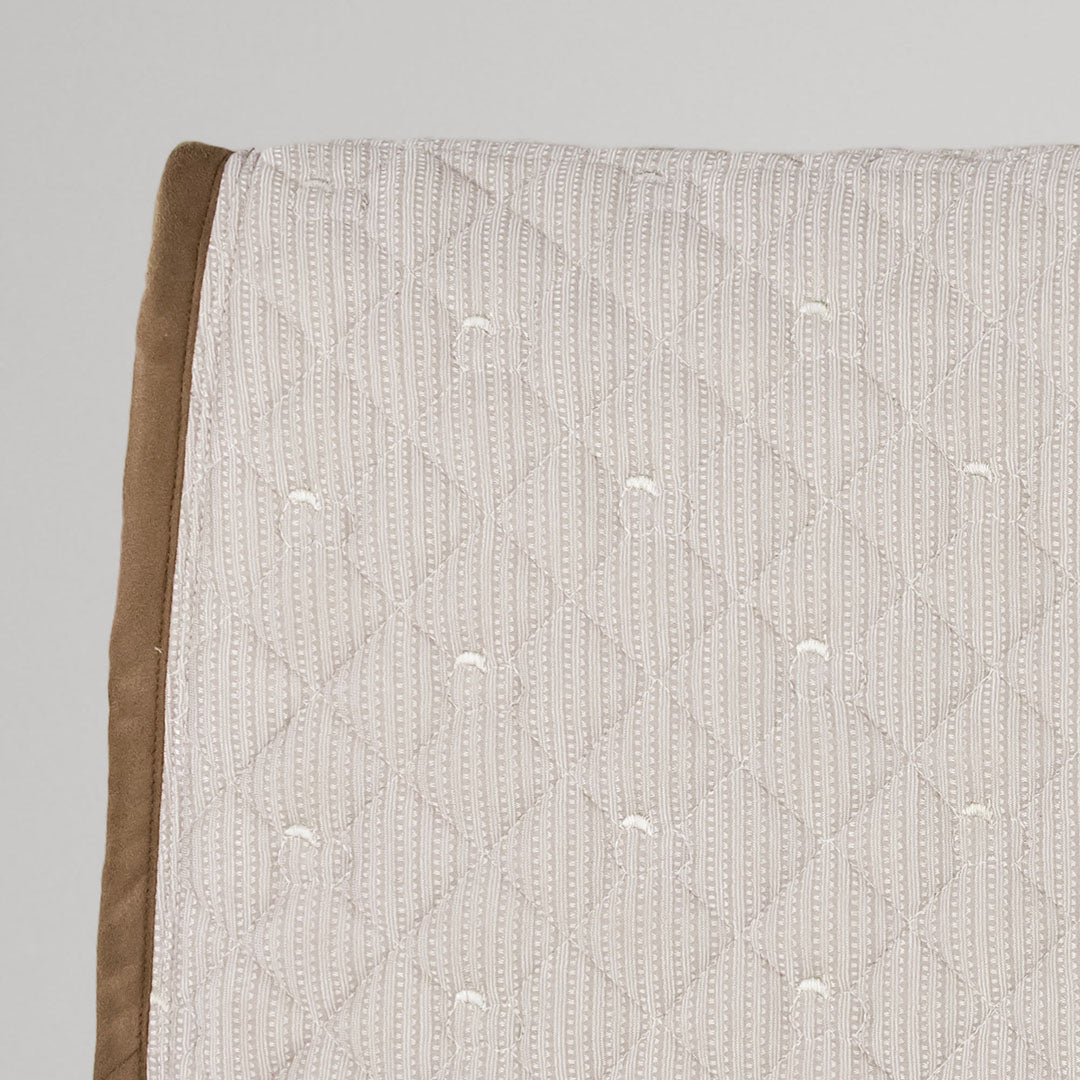 Textured fabric with a subtle pattern on a gray background