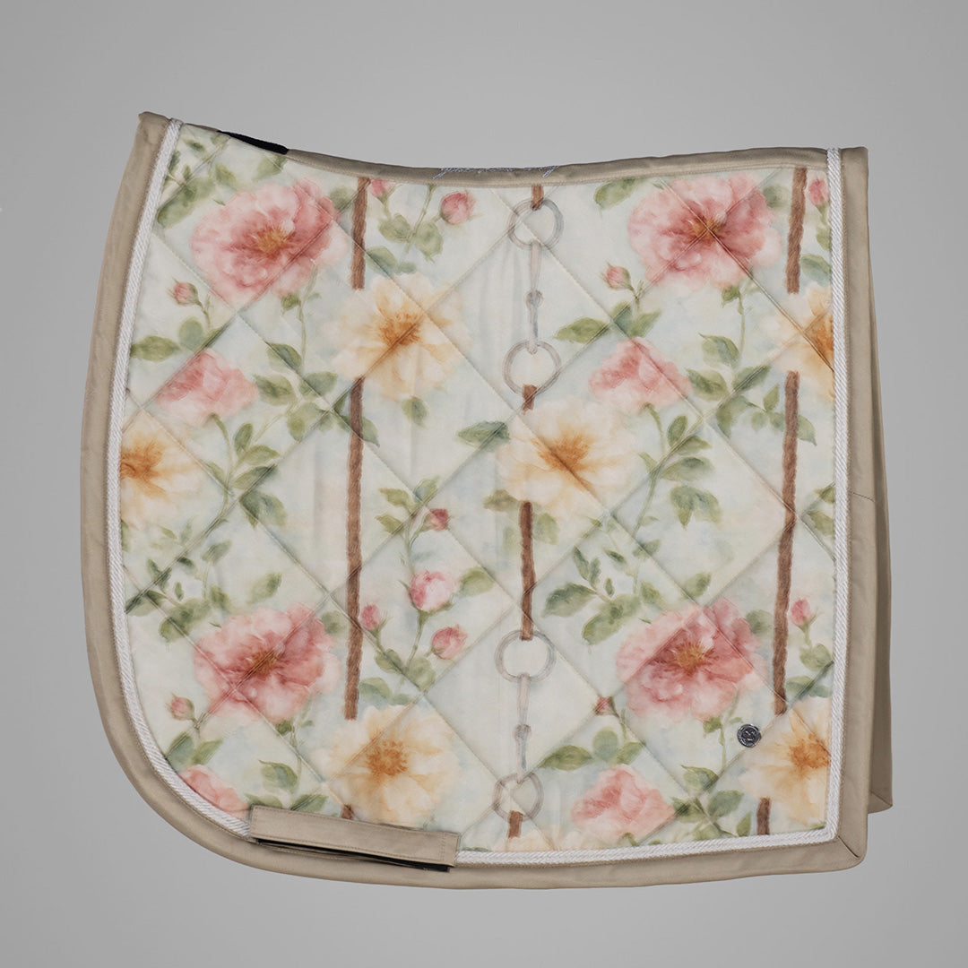 Floral patterned saddle pad on a gray background