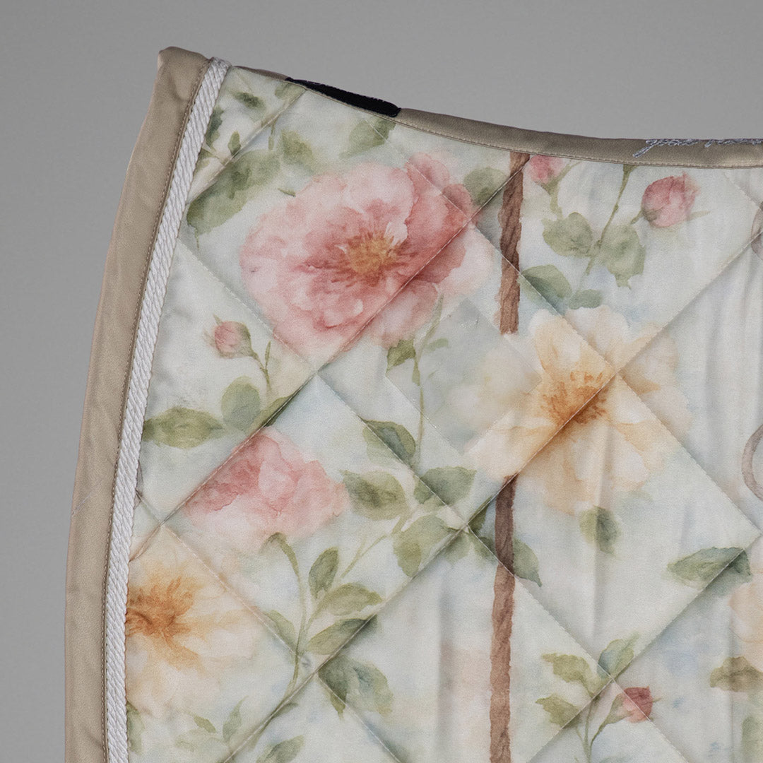 Floral quilt with pink and beige flowers on a gray background