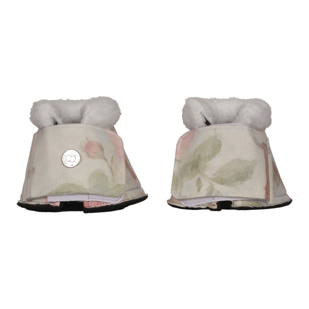 Pair of floral-patterned horse boots with white fur on a white background