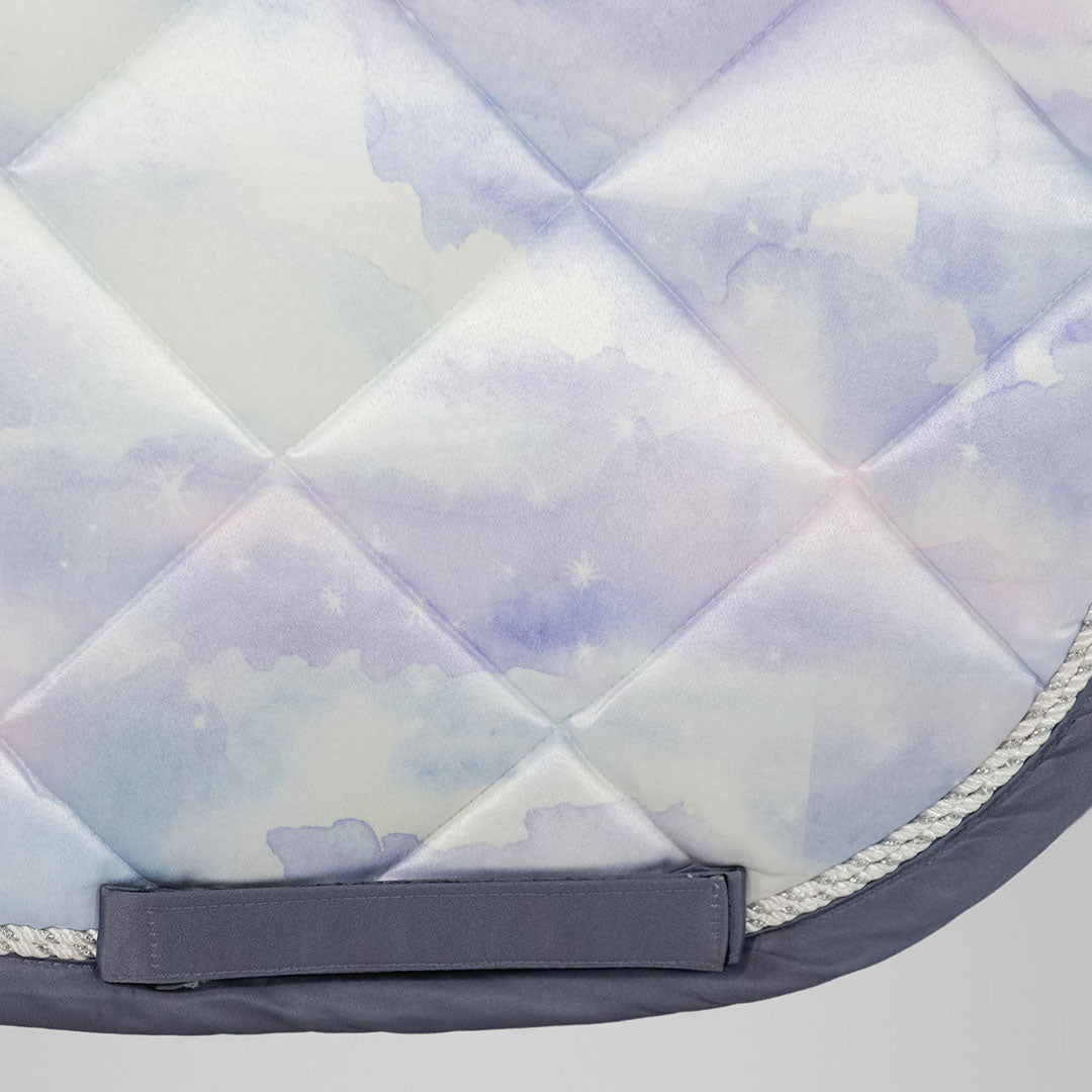 Quilted saddle pad with a cloud pattern on a light gray background