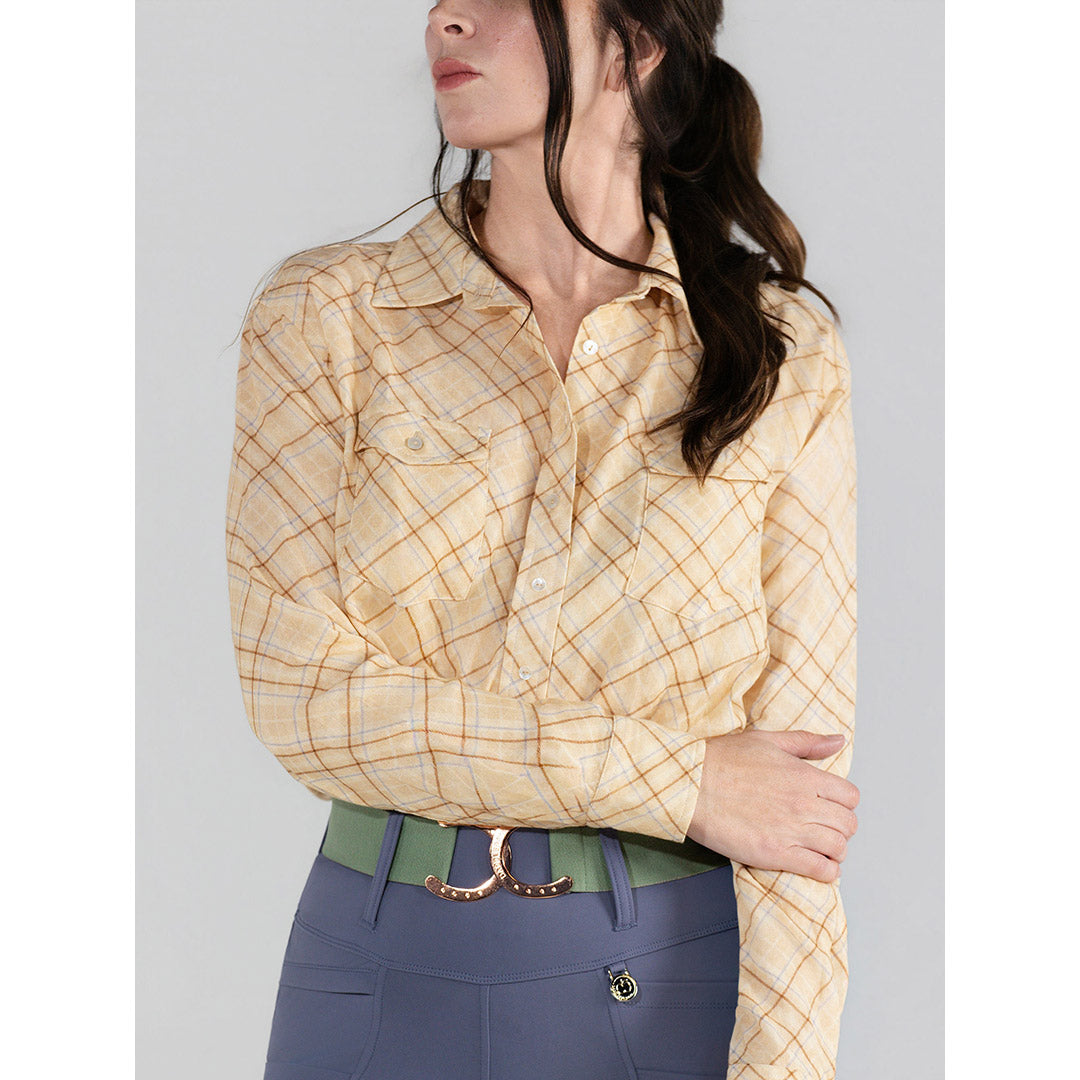 Woman wearing a yellow checkered blouse with a gray background