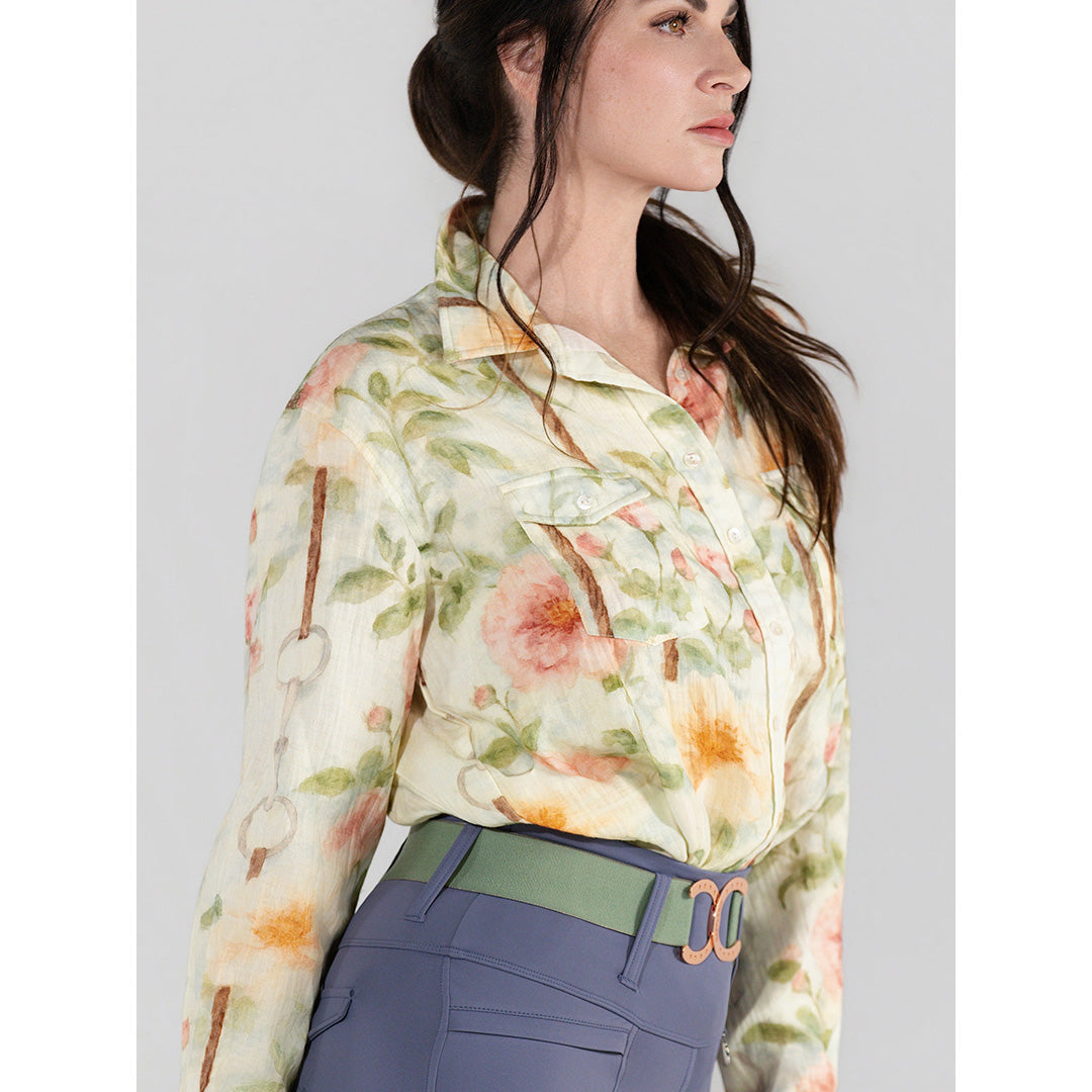 Woman wearing a floral blouse with a plain background