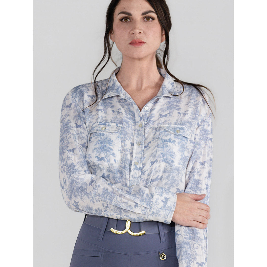 Woman wearing a light blue floral blouse with a plain background