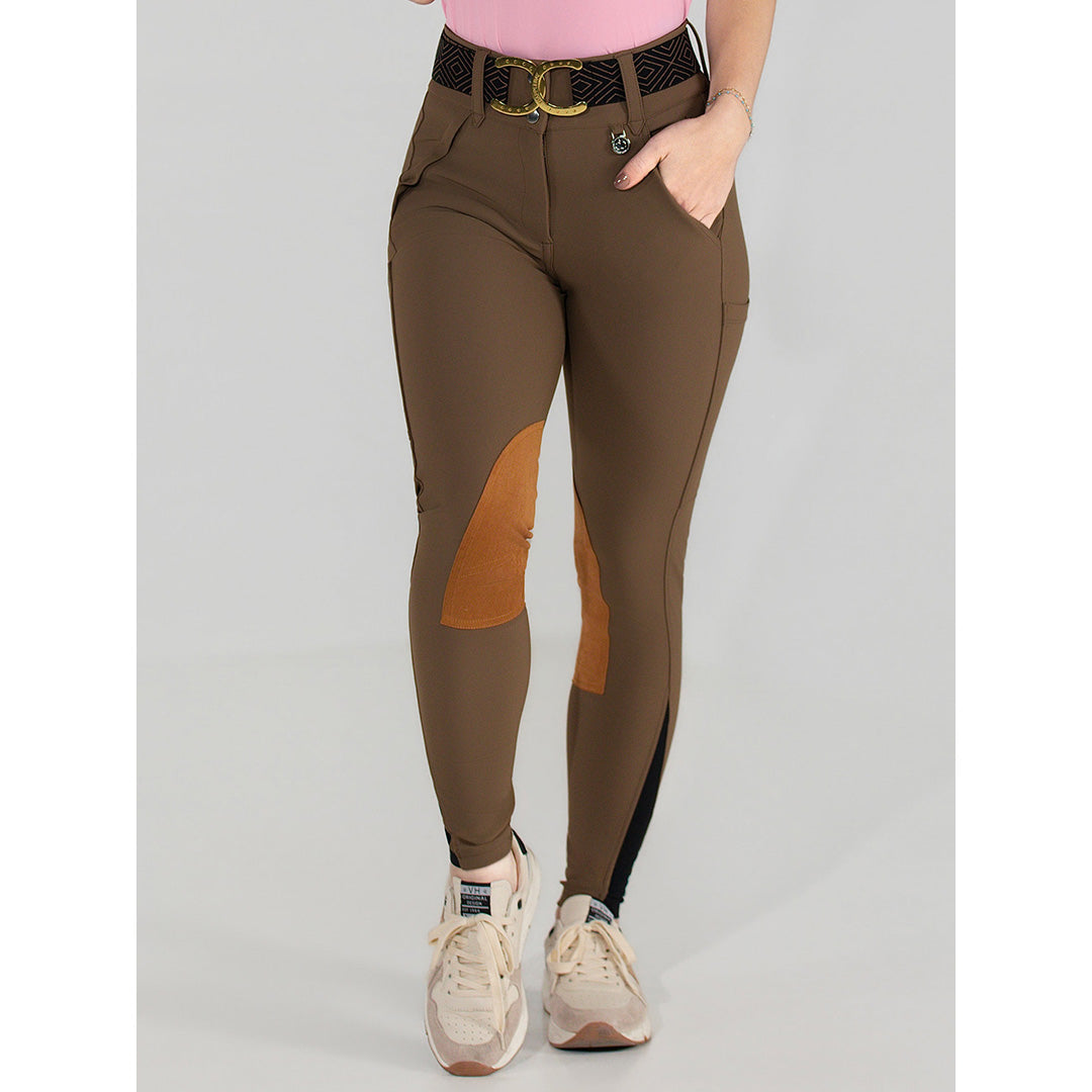 Brown equestrian pants with orange patches worn by a person on a gray background