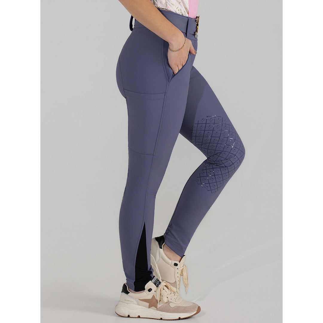 Person wearing purple riding pants with quilted design on a gray background