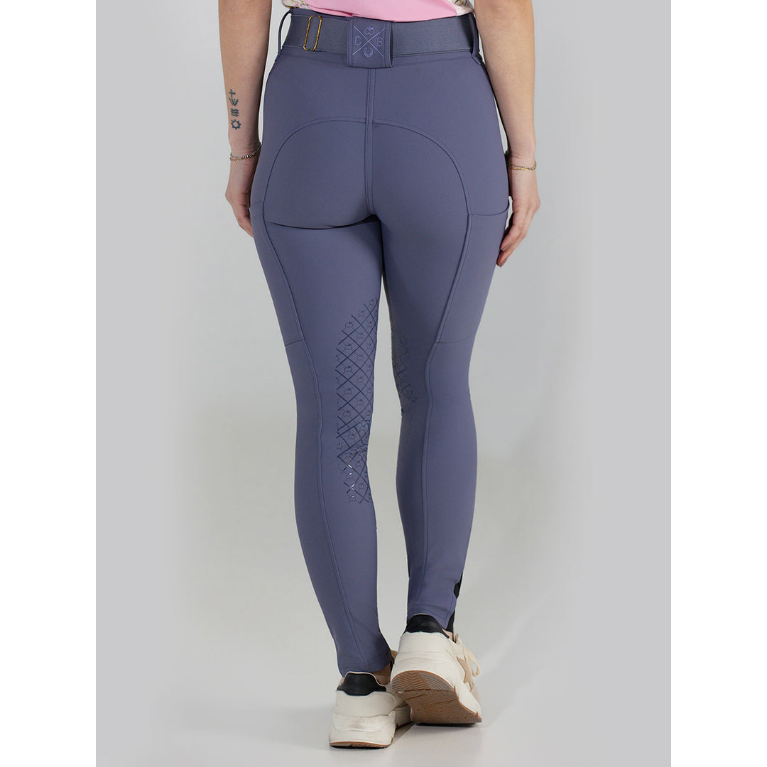 Purple riding pants worn by a person on a light gray background