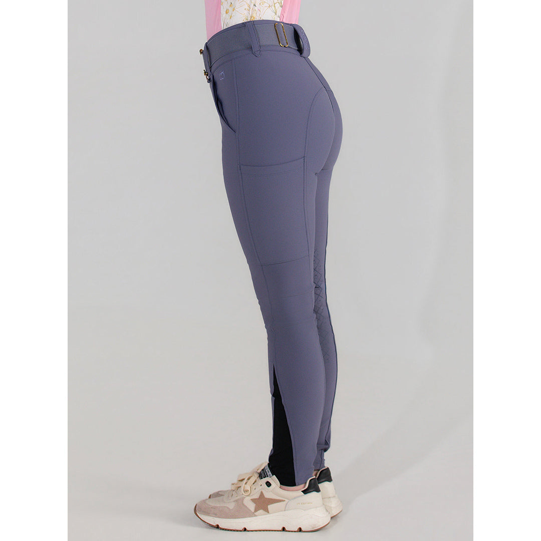 Purple riding pants worn by a person on a gray background