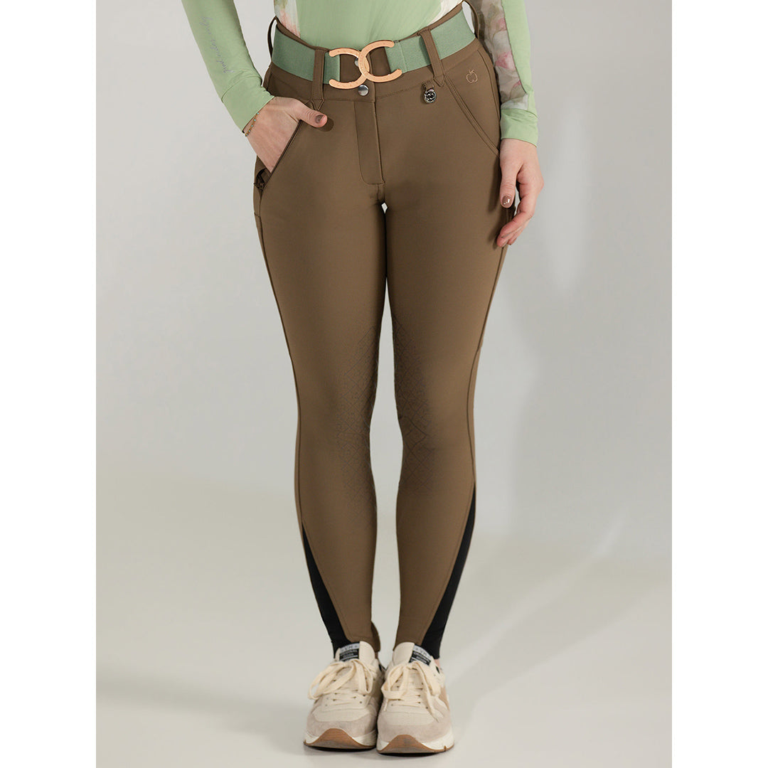 Brown riding pants with a belt worn by a person on a plain background