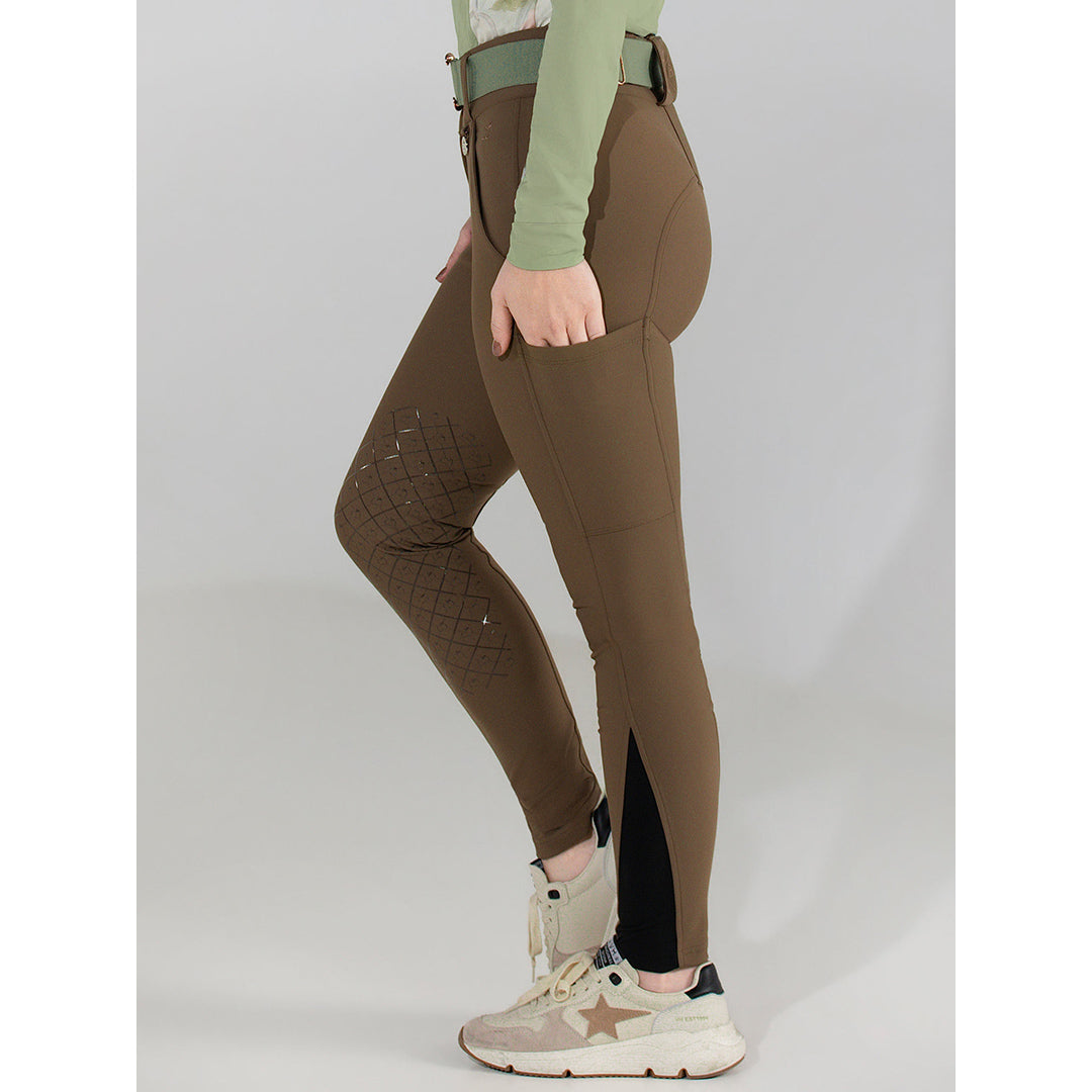 Brown riding pants worn by a person on a plain background