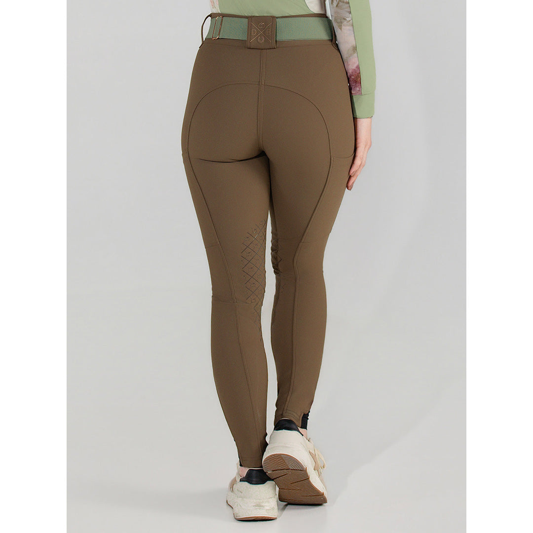 Brown riding pants worn by a person on a white background