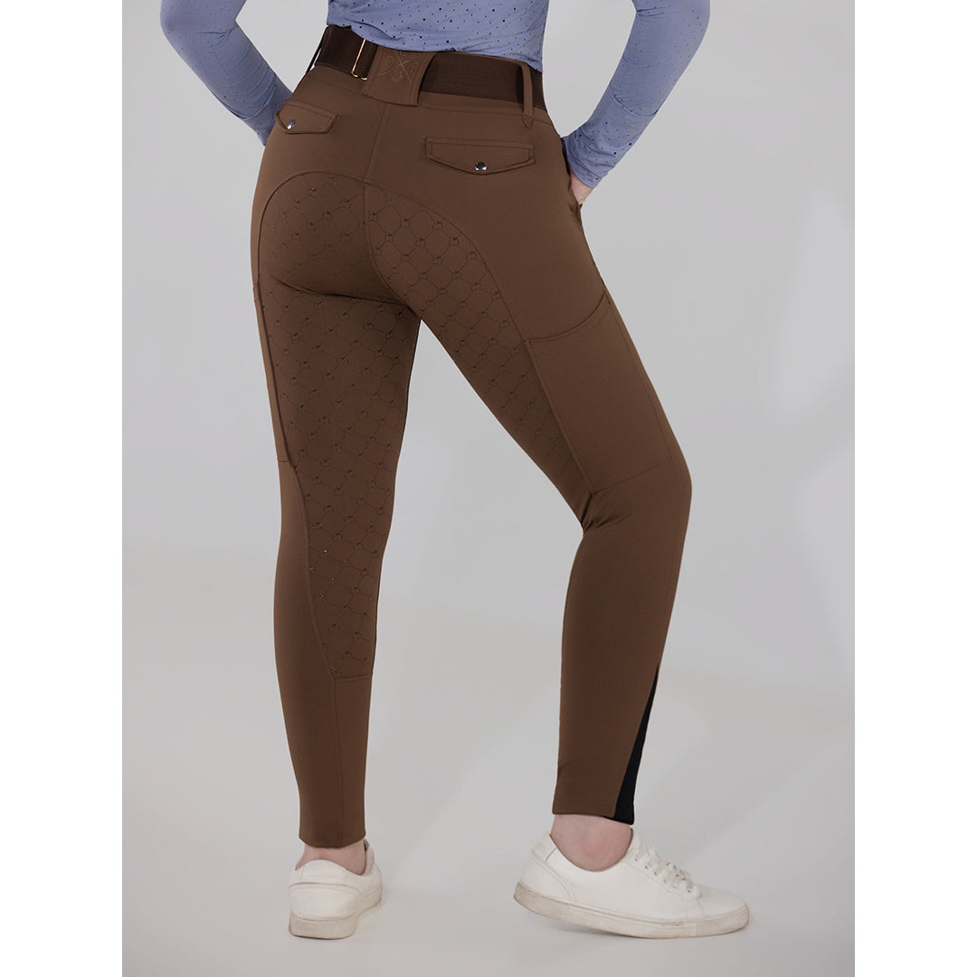 Brown riding pants worn by a person on a gray background