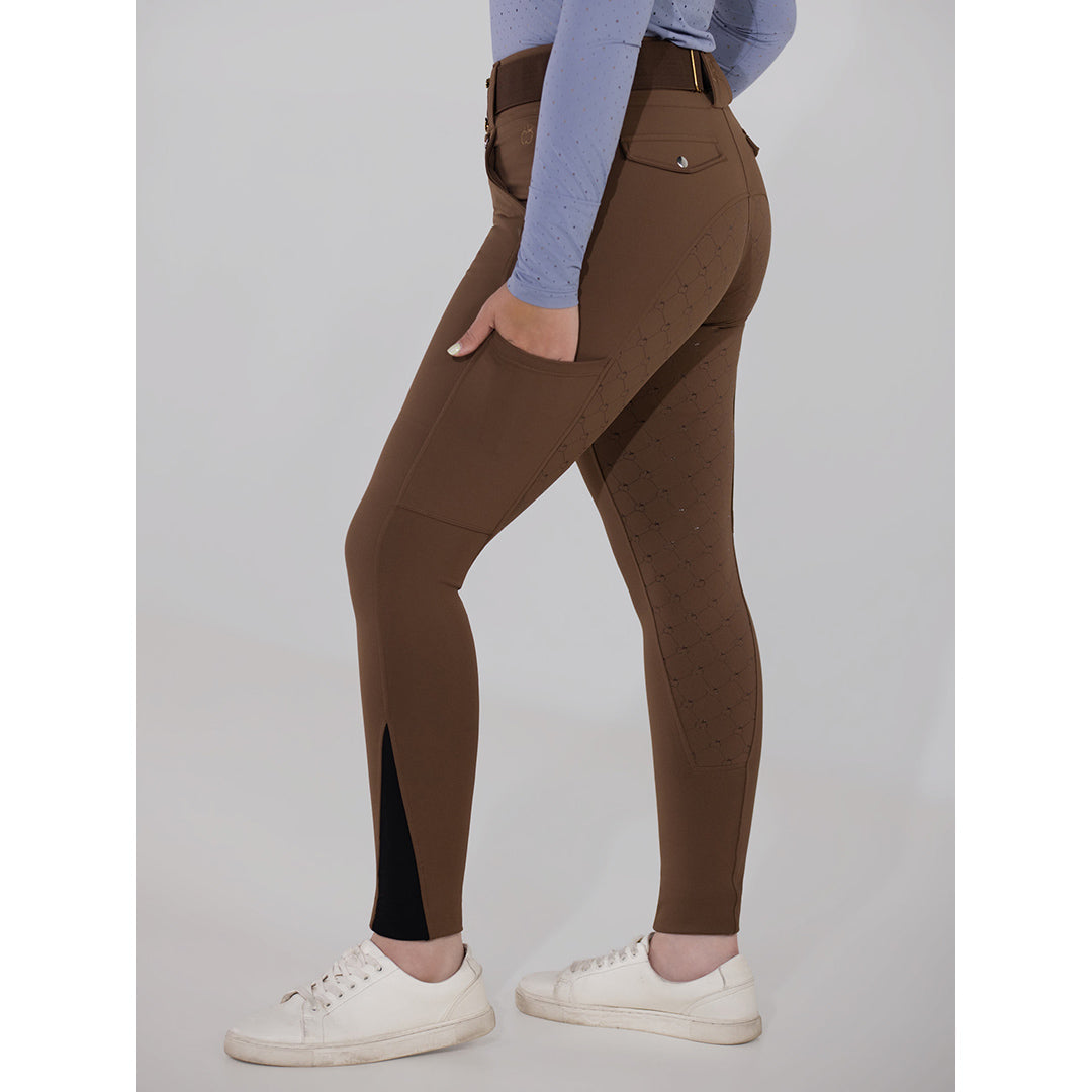 Brown riding pants worn by a person on a gray background