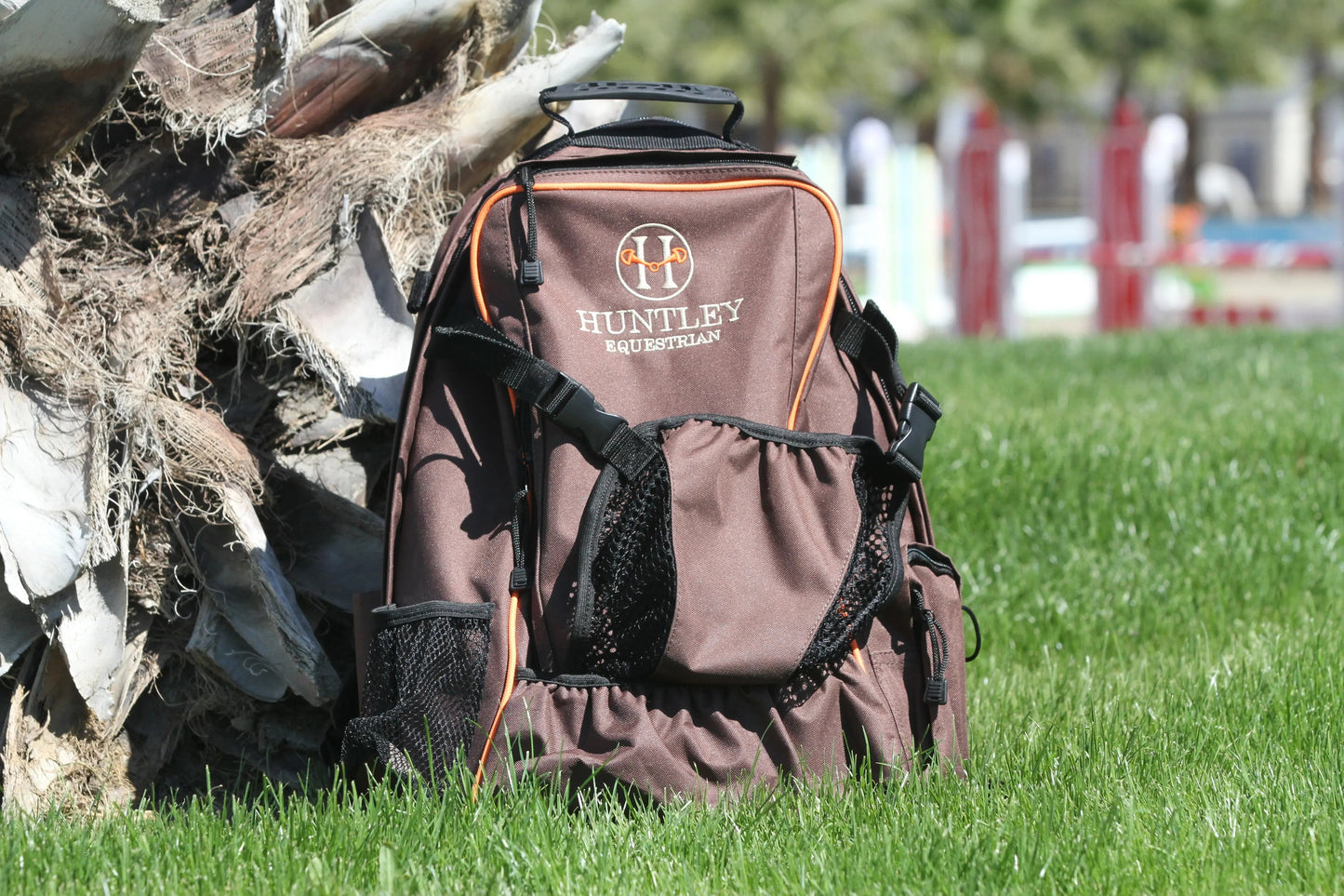 Brown hunting backpack with 'Huntley' branding on grass