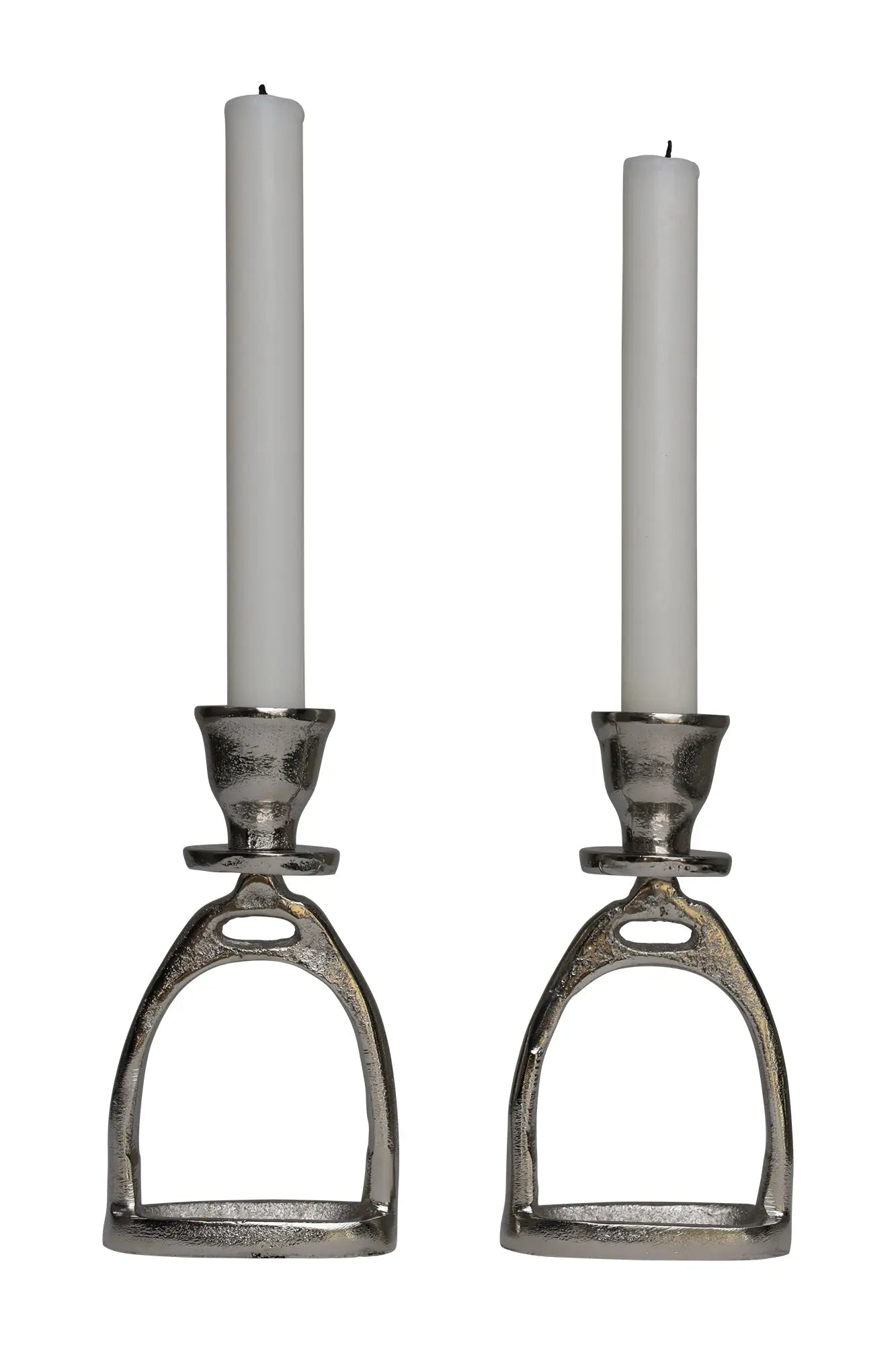 Two candle holders shaped like horse stirrups with white candles on a white background