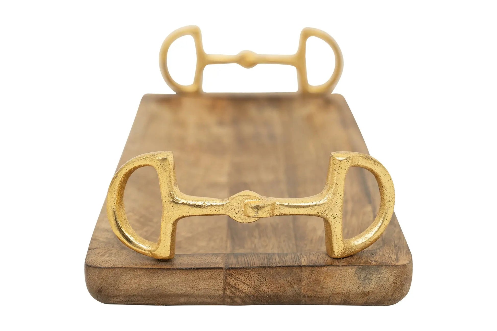 Gold metal bridle bit on a wooden stand with a white background
