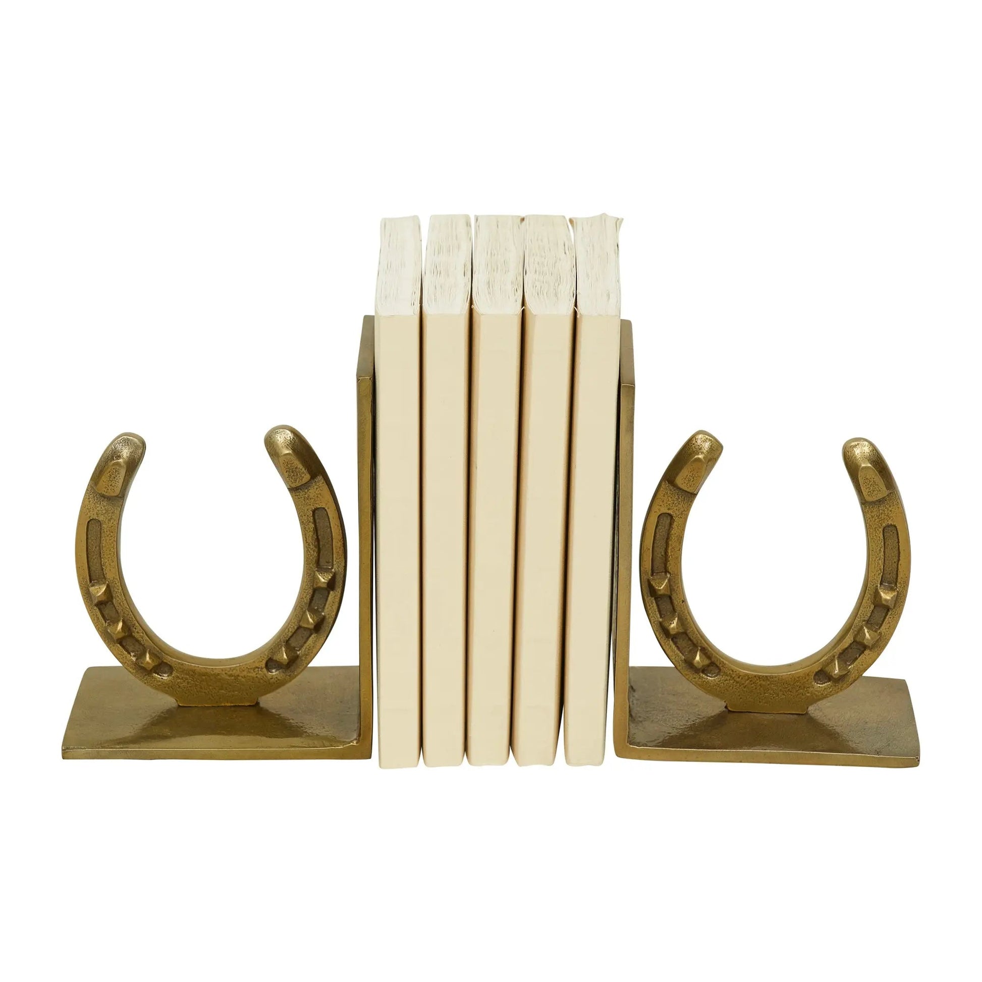 Gold horseshoe bookends holding books on a white background