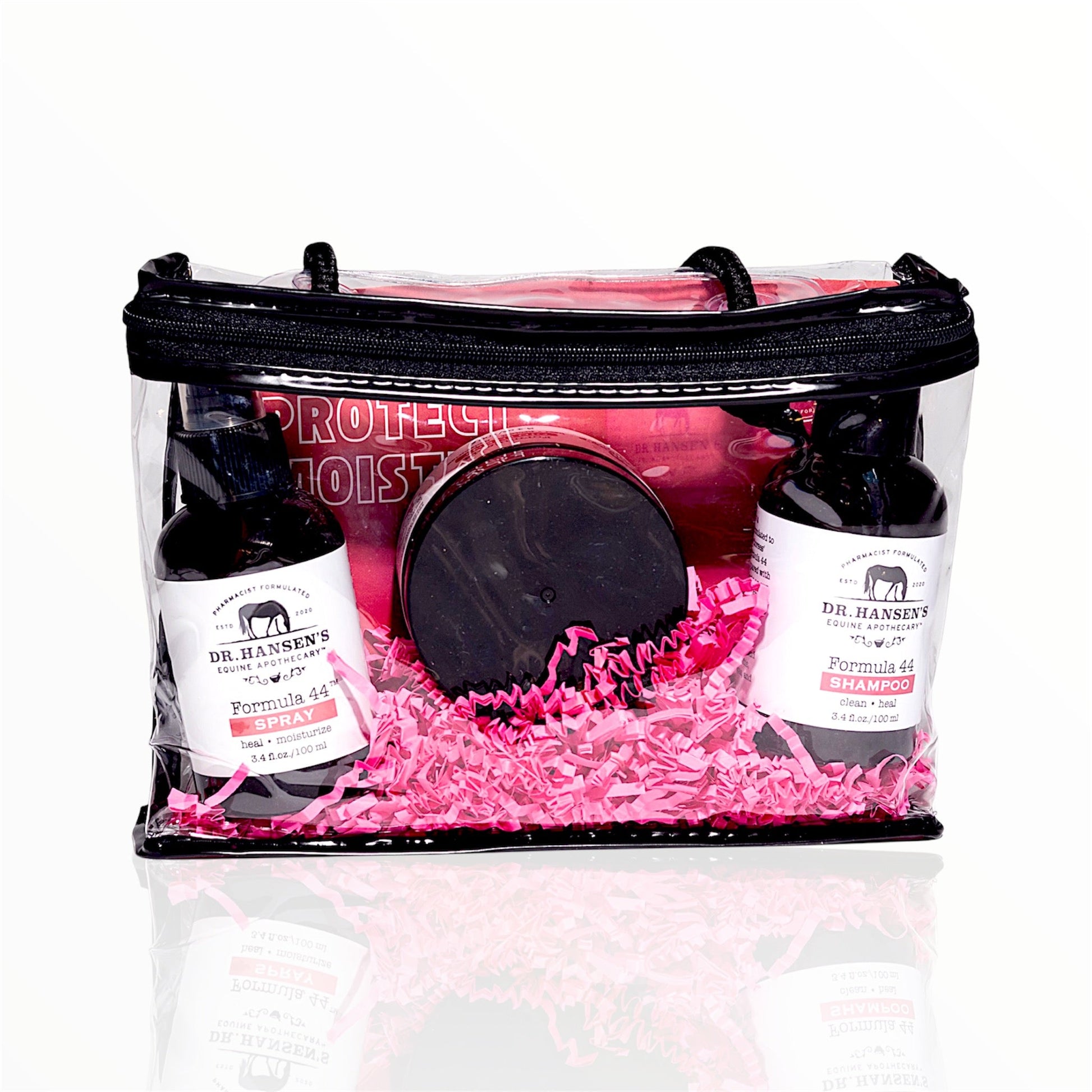 Clear gift bag with pink interior containing Dr. Hansen's shampoo and conditioner bottles.