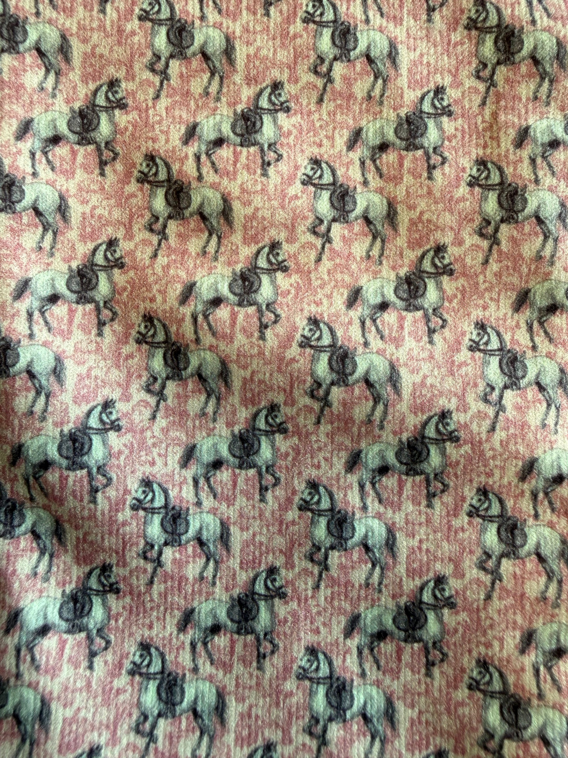 Pattern of horses on a pink background