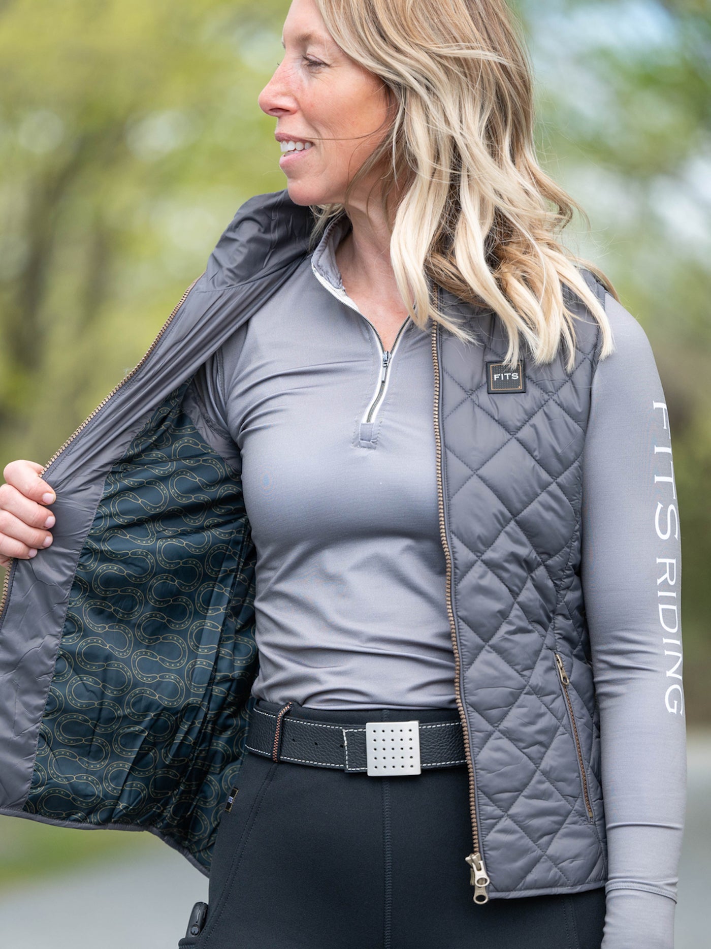 Grey quilted riding vest with printed lining.