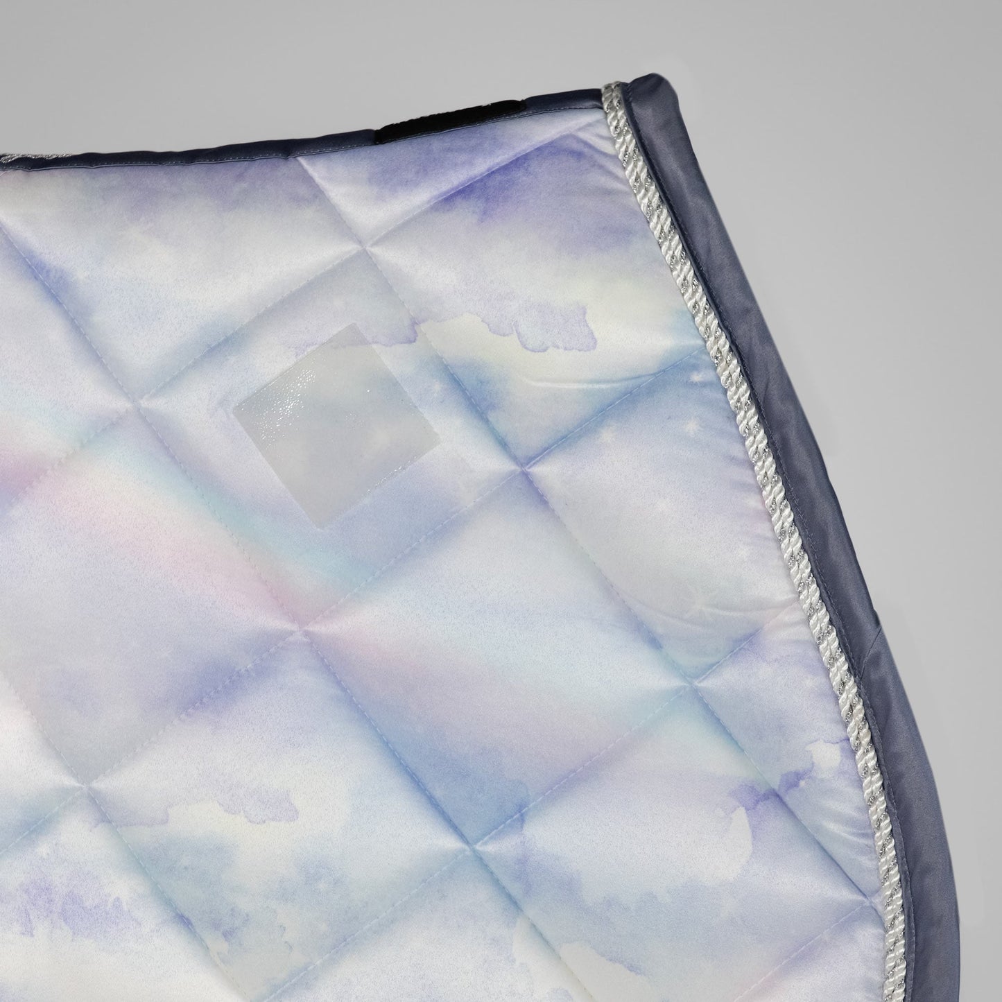Quilted fabric with a geometric pattern on a gray background