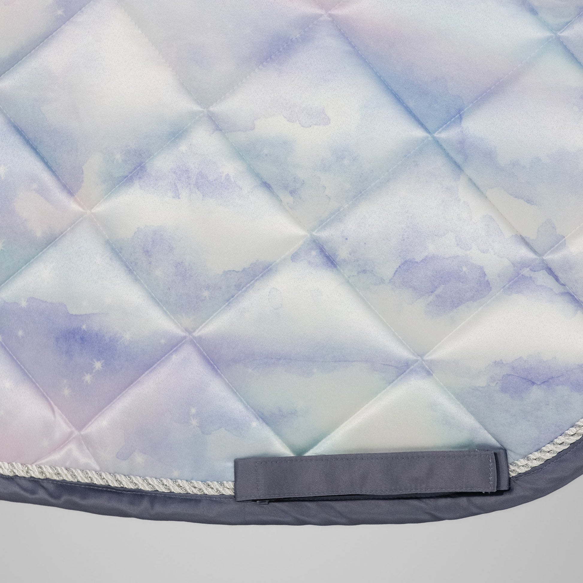 Quilted horse saddle pad with diamond pattern on a light gray background