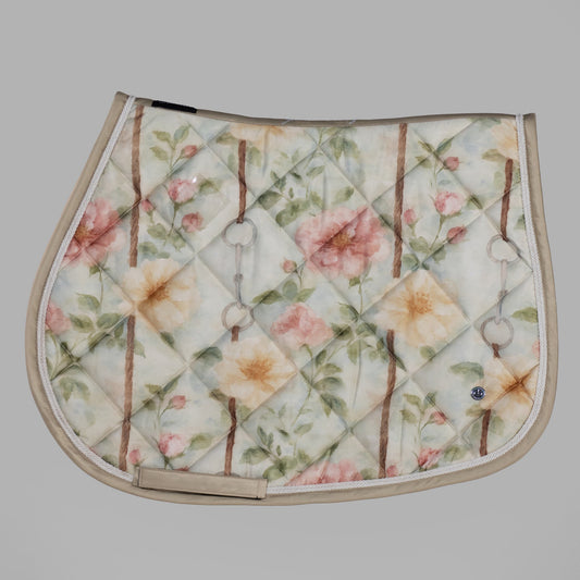 Floral patterned saddle pad on a gray background